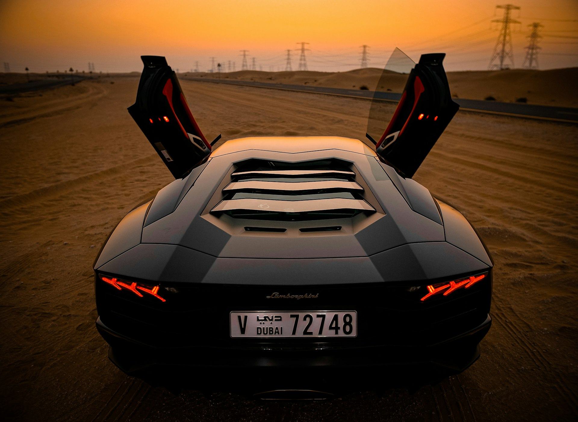 Lamborghini Aventador driving away, doors raised